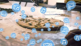 Animation of network of connections with icons over fresh pizza in kitchen. Global business, connections, computing and data processing concept digitally generated video. - Powered by Shutterstock - Get 15% off with code: PIKWIZARD15