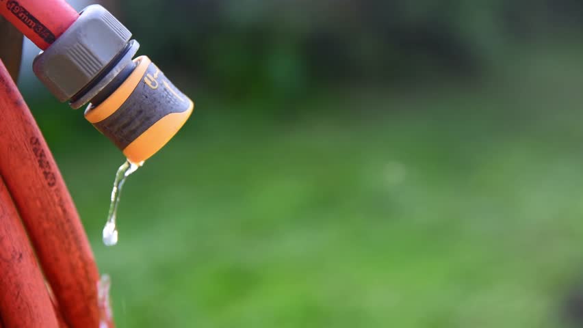 water dripping from hose, gardening, watering plants, saving water, with copy space