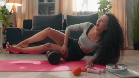 Sporty slim Hispanic Arabian ethnic woman sport female fitness girl sportswoman in sportswear massaging leg muscles roller equipment rolling tool mat sudden pain ouch painful myofascial massage indoor - Powered by Shutterstock - Get 15% off with code: PIKWIZARD15