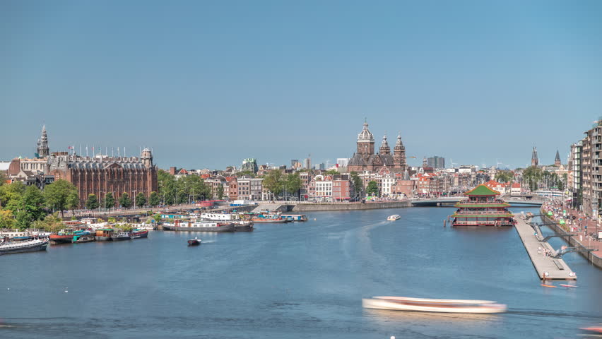 Aerial panorama of a Chinese restaurant in the form of pagoda on the water, set against the backdrop of historical city center buildings and floating boats on a river timelapse. Amsterdam, Netherlands