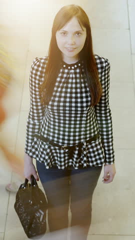 A Stylish and Fashionable Woman Displaying Checkered Style While Walking on City Streets