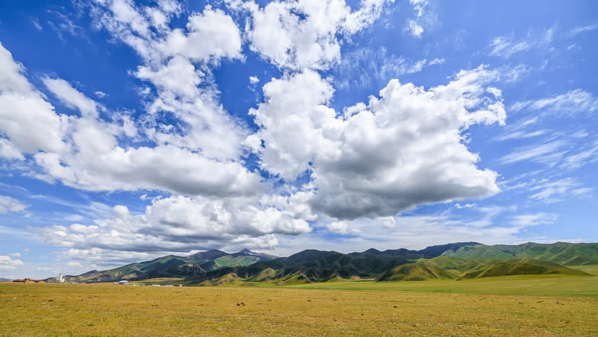 Beautiful grassland and sky clouds nature landscape on a sunny day. Blue sky and white clouds background.
