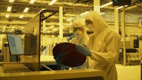 Cleanroom Technicians Hold Silicon Wafer in a Advanced Semiconductor Fabrication Facility. High Tech Machinery, Lithography Etching Equipment, Precision of Modern Microchip Production Processes. - Powered by Shutterstock - Get 15% off with code: PIKWIZARD15