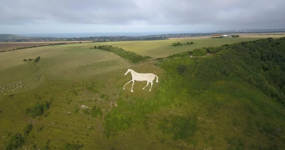 Aerial view of Litlington White Horse chalk hill horse figure in the South Downs, England UK, Orbit Left view