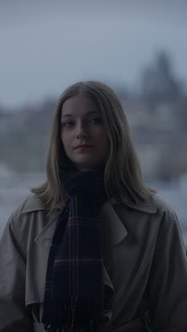 A Contemplative Woman in an Urban Setting, Dressed Warmly for the Chilly Weather