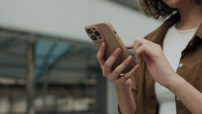 Close Up View of the Hands Holding Cell Phone and Chatting in Social Media while Standing Outdoors. Young Girl Going Outdoors and Texting Back on Telephone. People and Technology Concept - Powered by Shutterstock - Get 15% off with code: PIKWIZARD15
