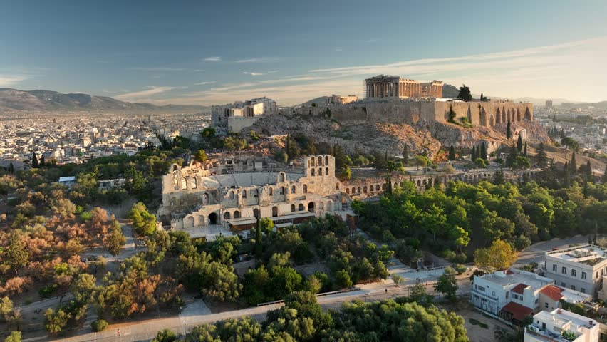 Aerial Views of Athens Showcasing Ancient Acropolis and Stunning City Landscape During Sunrise. Fly above Iconic Parthenon and Surrounding Ancient Ruins in Athens, Greece