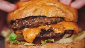 Juicy beef burger with tomatoes, melted cheese, Delicious juicy burger. High quality 4k footage - Powered by Shutterstock - Get 15% off with code: PIKWIZARD15