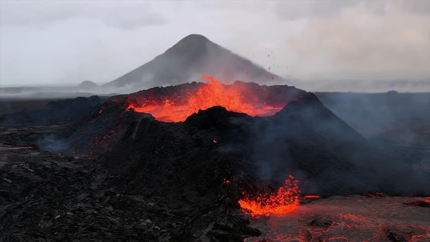 A volcano erupts in Iceland, spewing molten lava and ash, with lava flowing down the rugged volcanic landscape. Smoke and ash rise into the sky.