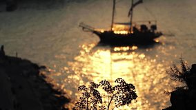 Sailing Ship at Sunset. Sailing Ship Silhouette With Shimmering, Golden Colored Sea Water Surface at Sunset. Sailing Holidays. Nautical Tourism. People Traveling. Sea Voyages. Nature Backgrounds. - Powered by Shutterstock - Get 15% off with code: PIKWIZARD15