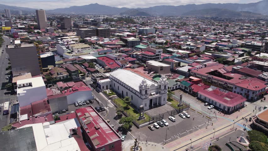 Aerial view of our lady of solitude catholic church, a prominent landmark in the heart of san jose, costa rica. circle dolly