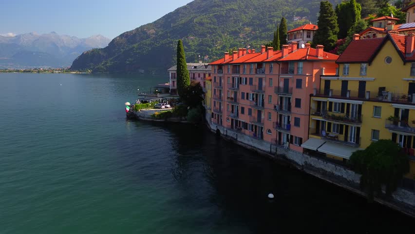 Aerial view of Lake Como. city ​​center. Bell tower. Tourism and romance. Mountains around the lake. Red roofs. Green Planet. Sailing yacht. Powerboat. travel to Italy, Bellano, 12.09.2024