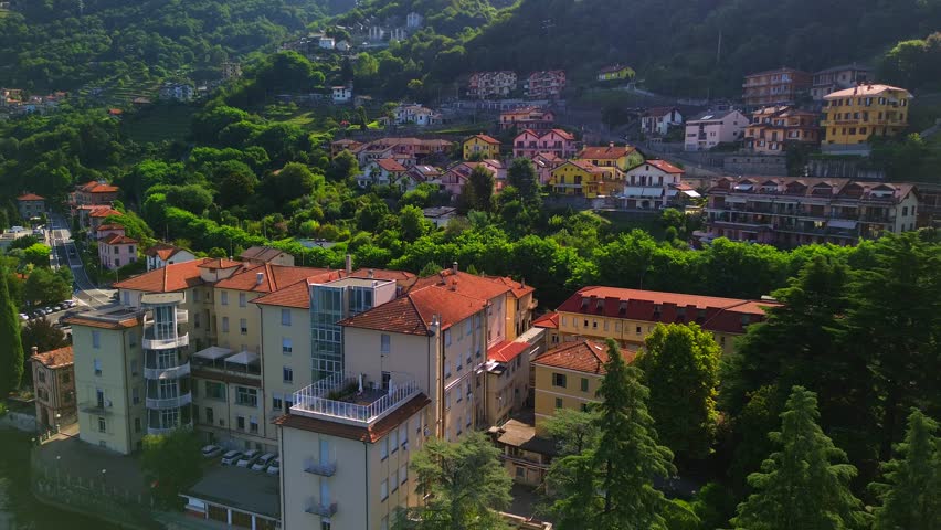 Aerial view of Lake Como. city ​​center. Bell tower. Tourism and romance. Mountains around the lake. Red roofs. Green Planet. Sailing yacht. Powerboat. travel to Italy, Bellano, 12.09.2024