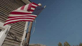 USA Flag of United State of America on a wooden building at blue sky background - Powered by Shutterstock - Get 15% off with code: PIKWIZARD15
