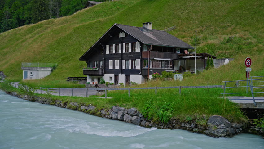 Wooden house in Switzerland in traditional style standing in a picturesque place near a mountain river Switzerland