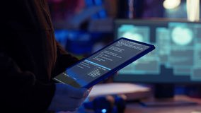 Hacker using VPN as anonymity tool to mask his online identity while committing data breaches using tablet. Cybercriminal in bunker masking his location, hacking with device, camera B close up - Powered by Shutterstock - Get 15% off with code: PIKWIZARD15