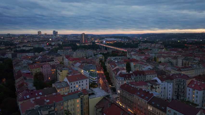 City lights gradually brightening as dusk envelops Prague