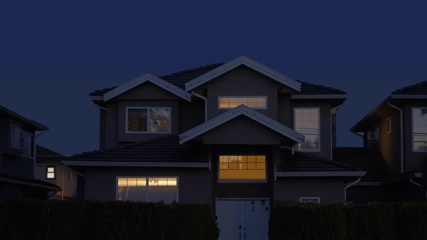 Establishing shot. Two story stucco luxury house with big tree and nice landscape at night at Fall in Vancouver, Canada, North America. October 2023. ProRes 422 HQ.