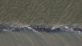 Sea waves and silt erosion controlled by rock jetty mole, breakwater - Powered by Shutterstock - Get 15% off with code: PIKWIZARD15