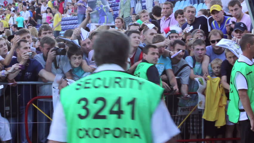 KIEV, UKRAINE - JUNE 13: Football security steward secures fan zone from players