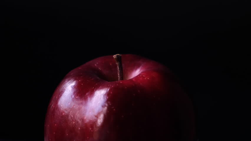 Close up of a delicious fresh and crisp red apple with black background.