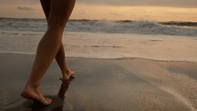 Woman or female feet barefoot on ocean beach. Tourist walking on the beach or coast by sea, enjoying the sunrise or sunset. Close up of legs and feet in the sea water. Travel, summer outdoors concept - Powered by Shutterstock - Get 15% off with code: PIKWIZARD15