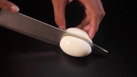 Cutting fresh boiled egg into half. - Powered by Shutterstock - Get 15% off with code: PIKWIZARD15
