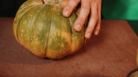 The cook slices a ripe orange pumpkin. Pumpkin dish. Autumn food concept 4k - Powered by Shutterstock - Get 15% off with code: PIKWIZARD15