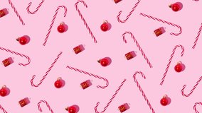 Candy cane, gift box and Christmas ball on pink background.. Christmas pattern. Minimal holiday concept. Moving image. - Powered by Shutterstock - Get 15% off with code: PIKWIZARD15