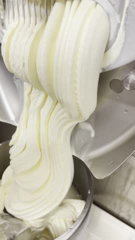 ice cream production, vanilla ice cream comes out of the machine