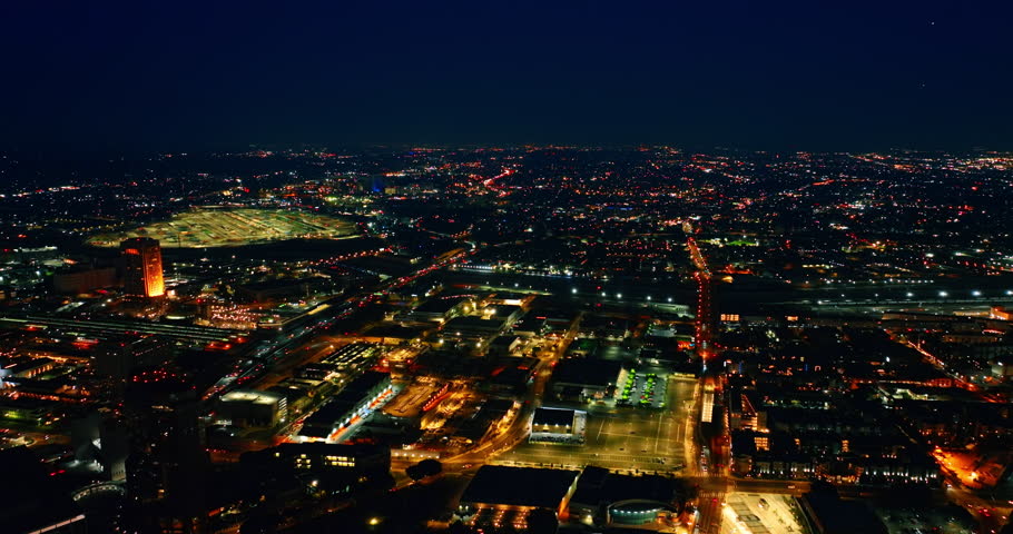 Vibrant nightlife of a modern metropolis. Lively traffic on the highways of Los Angeles, California, USA at night. Aerial view.