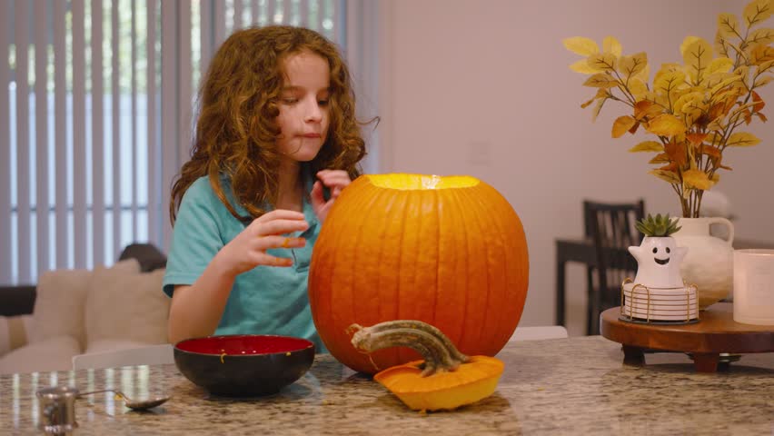 Boy carving pumpkin for halloween