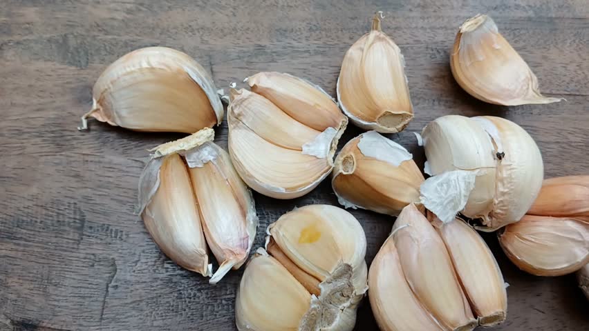 Close up of a collection of fresh garlic cloves. Garlic cloves from the air. Garlic market.
