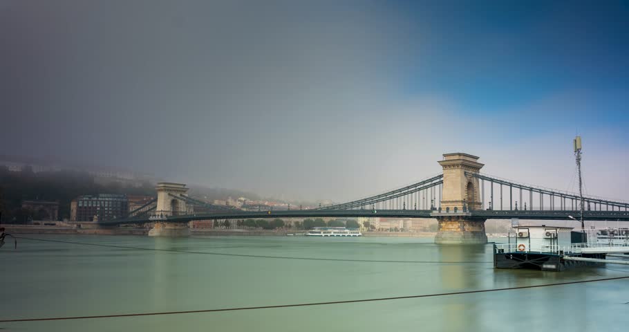 Budapest, Hungary - October 7, 2024: Budapest’s Chain Bridge Cloaked in Tranquil Morning Fog. Timelapse, slide transition.