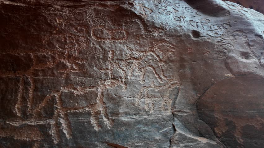 close up of 2000 years old Anfashieh inscriptions of Khazali canyon from the ancient bedouin nomads, etched into the rock surfaces of Jordan's majestic Wadi Rum desert