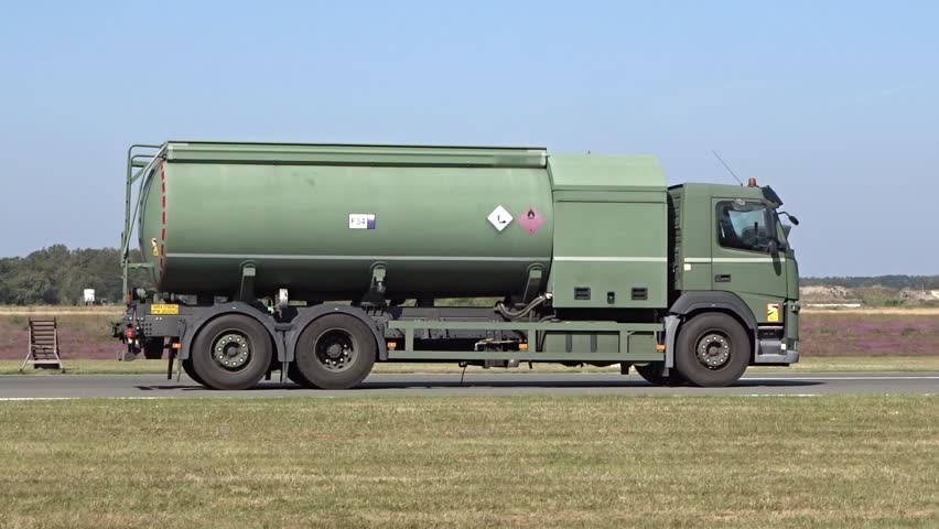 military fuel truck actively handling logistics busy airport runway airbase essential support operations for flight aircrafts always prepared action service air force driving taxiway