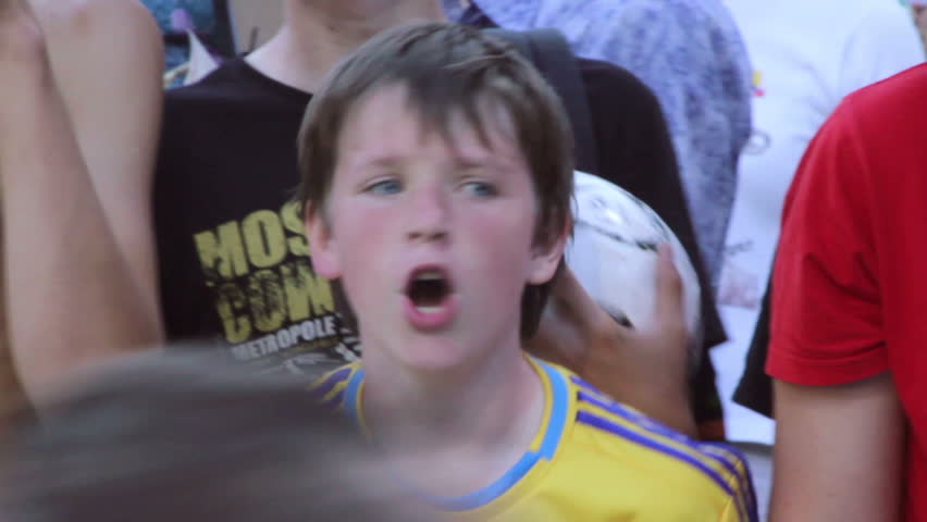 KIEV, UKRAINE - JUNE 13: Young boy, football fan, shouts after soccer match