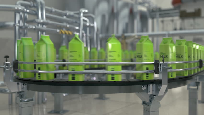Transporter Machine Moving Green Milk Cartons At Production Factory. Industrial Factory Transporter Machine For Packaging Process Automation. Manufactured Beverage On Factory Transporter Machine