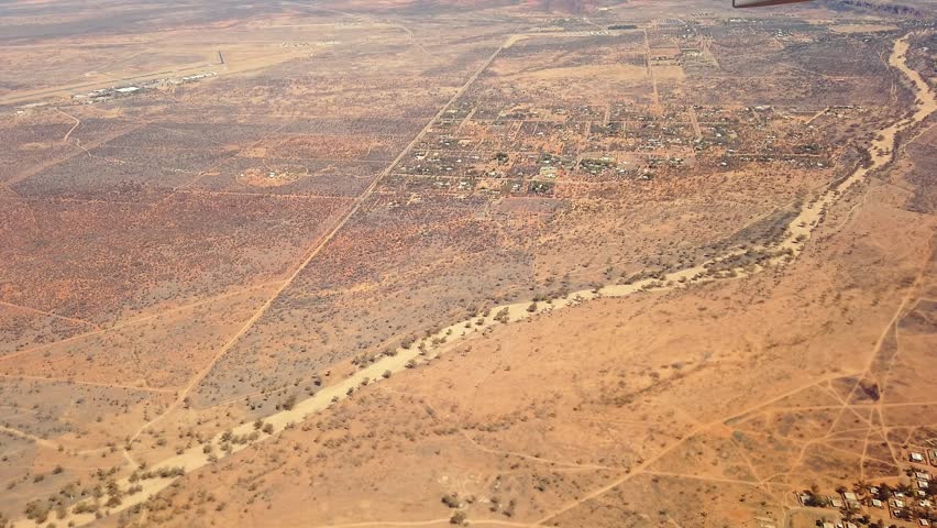 Flying on Alice Springs Macdonnell ranges desert of Red Centre. Central Australia in the dry season. Aerial view in Red Centre of Northern Territory in Central Australia. Scenic flight for tourists.