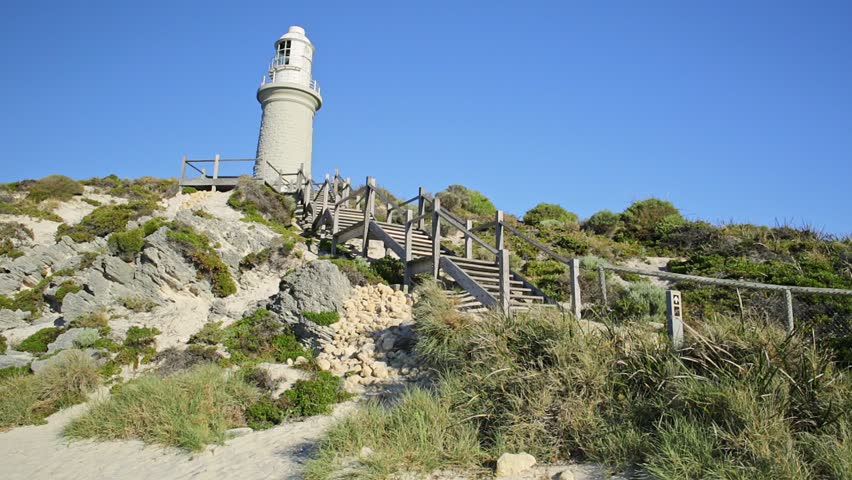 Stairs leading up to Bathurst Lighthouse in north coast of Rottnest Island, near Perth, Western Australia. Sunny afternoon with blue sky.
