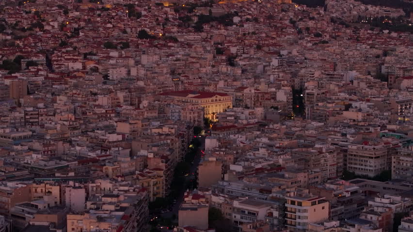 Aerial view capturing the glowing Aristotelous Square and Ministry of Macedonia and Thrace Amid the vast urban expanse of Thessaloniki, Greece, as twilight envelops the city