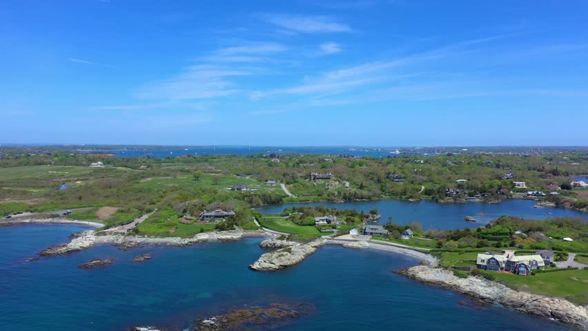 Beautiful epic aerial drone view of the bay with green coastlines sea walls breakers roads and houses on the back bays