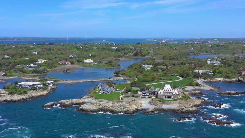 Beautiful epic aerial drone view of the bay with green coastlines sea walls breakers roads and houses on the back bays