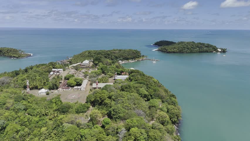 Drone slowly flies left high over Royal Island with view of Devil