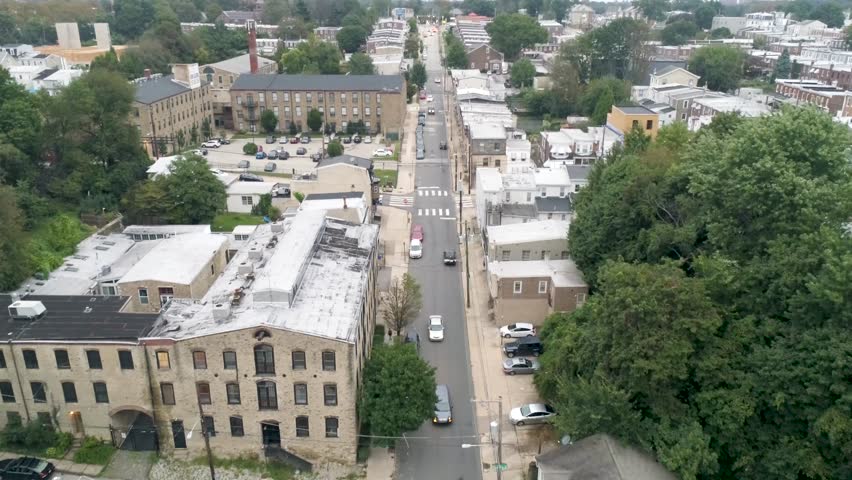 Aerial of streets, buildings and row homes in Manayunk Roxborough area of Philadelphia Pennsylvania