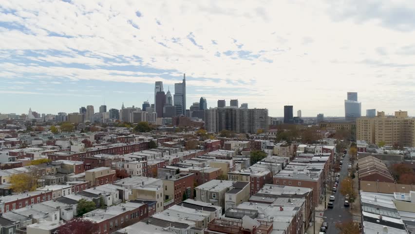 Aerial of Philadelphia Pennsylvania skyline, buildings and row homes on a sunny day