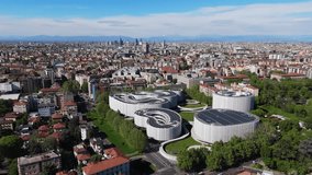 Aerial of Milan city Italy, drone fly above famous Bocconi University with panoramic view of Alps mountains at distance - Powered by Shutterstock - Get 15% off with code: PIKWIZARD15
