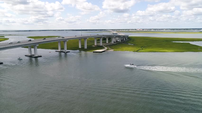 Ocean City New Jersey aerial on a summer day with boat approaching bridge