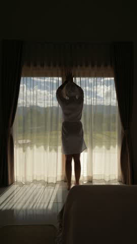 Luxury Villa Morning: Woman In White Bathrobe Opening Curtains With Scenic Rice Field View