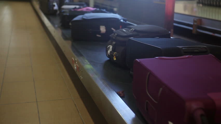 Different luggage on airport conveyor belt